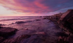 Preview wallpaper water, sea, stones, landscape, sunset, purple