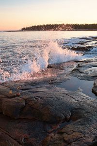 Preview wallpaper water, spray, shore, stones, sunset