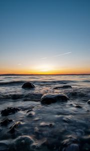 Preview wallpaper water, stones, sunset, horizon, landscape