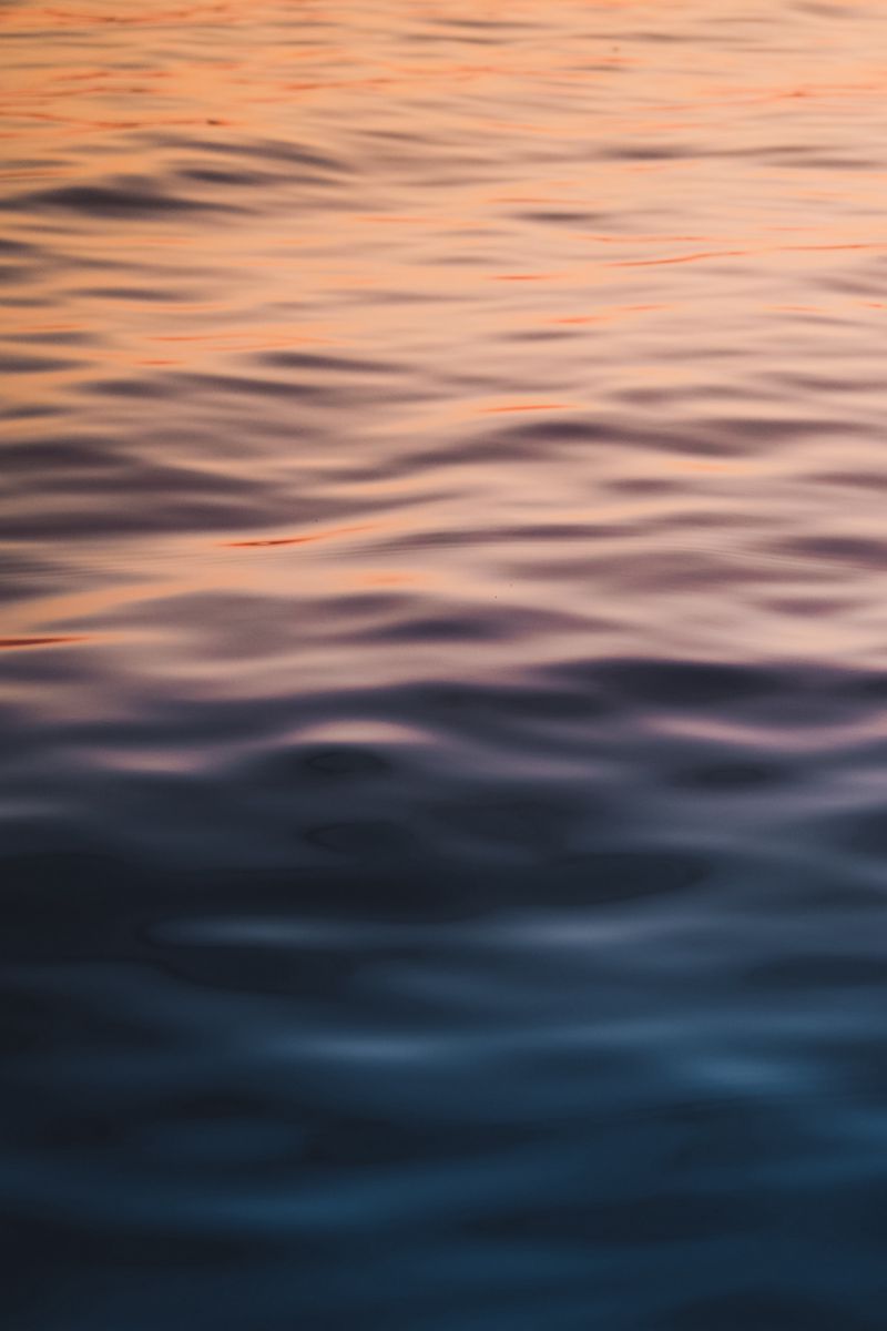 800x1200 Wallpaper water, waves, wavy, ripples, glare, sea