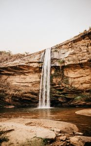 Preview wallpaper waterfall, cliff, river, stones, shore
