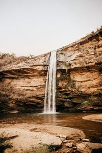 Preview wallpaper waterfall, cliff, river, stones, shore