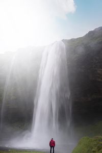 Preview wallpaper waterfall, cliff, sunlight, spray, man