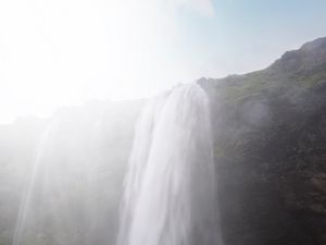 Preview wallpaper waterfall, cliff, sunlight, spray, man