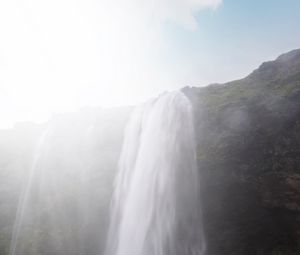 Preview wallpaper waterfall, cliff, sunlight, spray, man