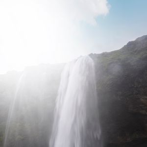Preview wallpaper waterfall, cliff, sunlight, spray, man