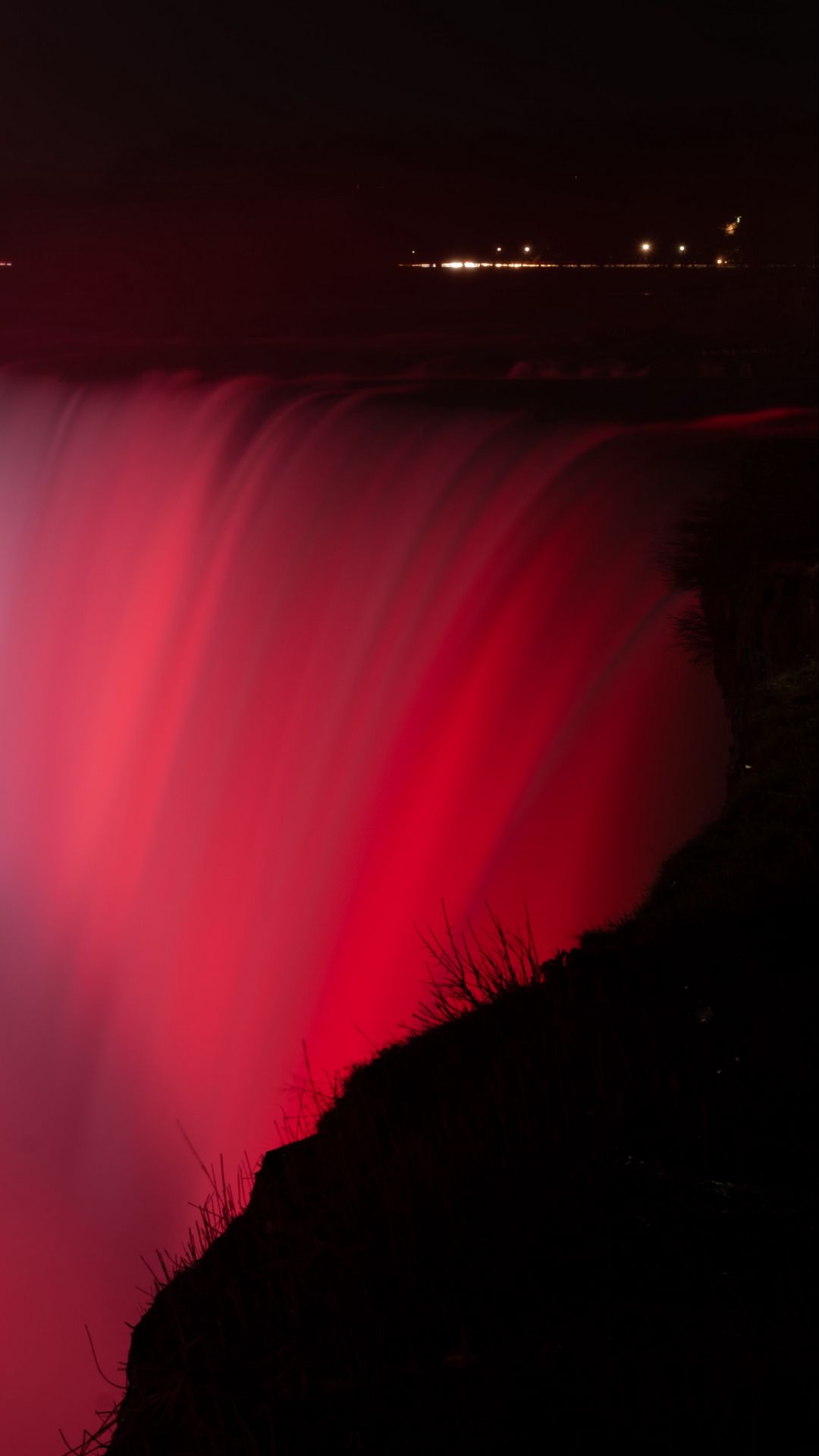 1080x1920 Wallpaper waterfall, fog, backlight, red, dark