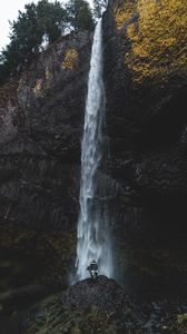 Preview wallpaper waterfall, human, rock, cliff, water