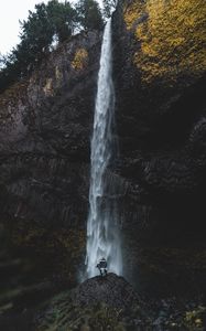 Preview wallpaper waterfall, human, rock, cliff, water