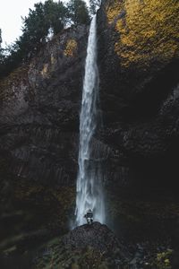 Preview wallpaper waterfall, human, rock, cliff, water