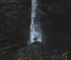 Preview wallpaper waterfall, human, rock, cliff, water