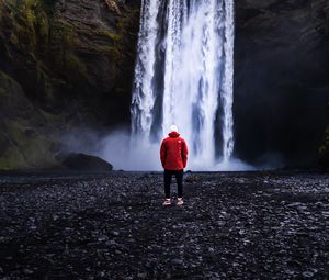 Preview wallpaper waterfall, man, shore, cliff, nature