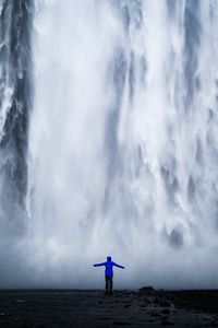 Preview wallpaper waterfall, man, silhouette, cliff, water