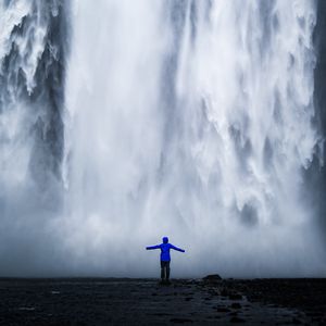 Preview wallpaper waterfall, man, silhouette, cliff, water