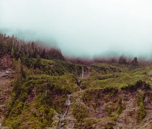 Preview wallpaper waterfall, mountain, cliff, fog, sky