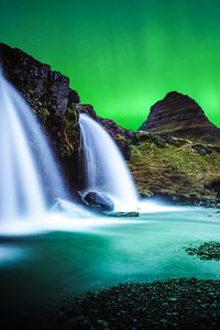 Preview wallpaper waterfall, mountain, water, pebbles, северное сияние, ночь