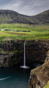 Preview wallpaper waterfall, rock, sea, valley, houses