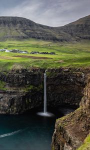 Preview wallpaper waterfall, rock, sea, valley, houses