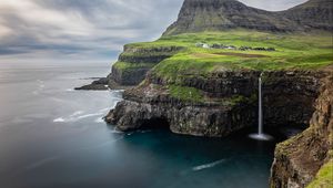 Preview wallpaper waterfall, rock, sea, valley, houses