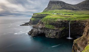 Preview wallpaper waterfall, rock, sea, valley, houses