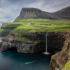 Preview wallpaper waterfall, rock, sea, valley, houses