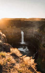 Preview wallpaper waterfall, rocks, cliff, rays, sky