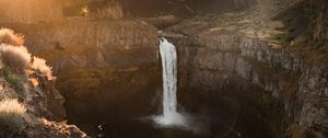 Preview wallpaper waterfall, rocks, cliff, rays, sky