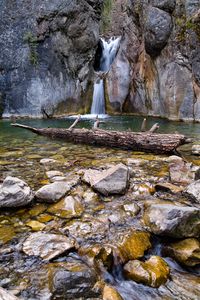 Preview wallpaper waterfall, rocks, stones, log, water