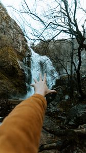 Preview wallpaper waterfall, rocks, trees, hand
