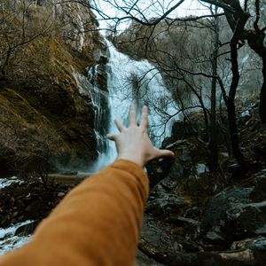 Preview wallpaper waterfall, rocks, trees, hand