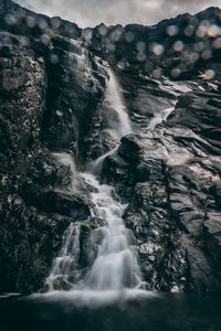 Preview wallpaper waterfall, stones, glare, bokeh, break