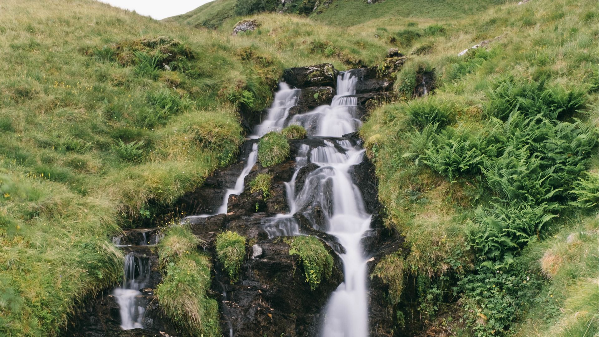 Download wallpaper 1920x1080 waterfall, stones, water, grass, landscape