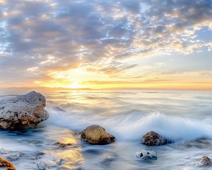 Preview wallpaper waves, sea, stones, shore, sky, clouds, sun, horizon
