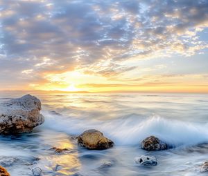 Preview wallpaper waves, sea, stones, shore, sky, clouds, sun, horizon