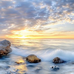 Preview wallpaper waves, sea, stones, shore, sky, clouds, sun, horizon