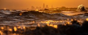 Preview wallpaper waves, sunset, city, buildings, silhouettes
