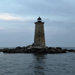 Preview wallpaper whaleback lighthouse, lighthouse, stones, sea, clouds, usa