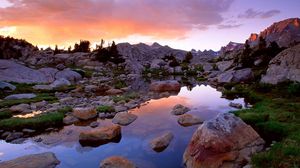 Preview wallpaper wind river range, wyoming, stones, river, mountains, evening, sky, grass