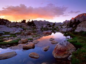 Preview wallpaper wind river range, wyoming, stones, river, mountains, evening, sky, grass