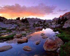 Preview wallpaper wind river range, wyoming, stones, river, mountains, evening, sky, grass