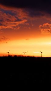 Preview wallpaper wind turbines, sunset, horizon, clouds