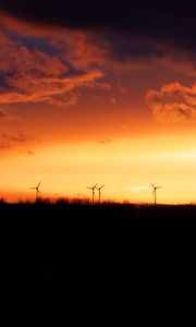 Preview wallpaper wind turbines, sunset, horizon, clouds