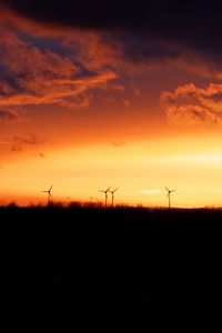 Preview wallpaper wind turbines, sunset, horizon, clouds