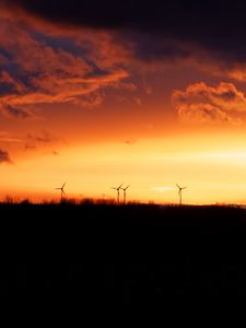 Preview wallpaper wind turbines, sunset, horizon, clouds