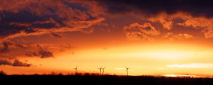 Preview wallpaper wind turbines, sunset, horizon, clouds