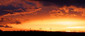 Preview wallpaper wind turbines, sunset, horizon, clouds