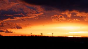 Preview wallpaper wind turbines, sunset, horizon, clouds