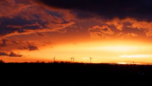 Preview wallpaper wind turbines, sunset, horizon, clouds