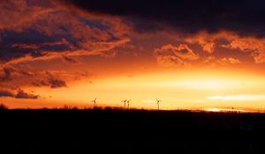 Preview wallpaper wind turbines, sunset, horizon, clouds