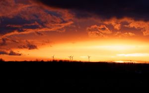 Preview wallpaper wind turbines, sunset, horizon, clouds